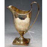 An Edwardian silver pedestal helmet form cream jug, 4.4oz, h.15cm