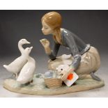 A Lladro porcelain figure group of Girl feeding the ducks, w.23cm