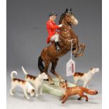 A Beswick hunting set, comprising rearing horse with huntsman, three hounds (one with tail re-