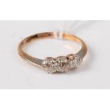 An 18ct gold and platinum three stone diamond ring, the three old cut diamonds, total estimated