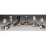 Three pairs of sterling silver dwarf candlesticks on loaded bases, the largest h.10cm