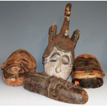 Four mid-20th century African masks, comprising Punu (Gabonb), Igbo (Nigeria), and two Baule (