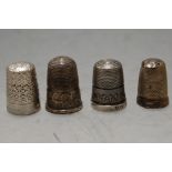 A collection of four various silver thimbles by Charles Horner