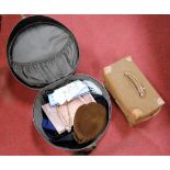 A brown leather travel case having a fitted interior, stamped with the intials JCS, in canvas