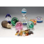 Assorted glass paperweights, polished agate stones, and a glass paperweight style scent bottle