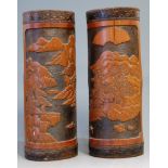 A pair of mid-20th century Chinese brush pots, each carved with mountain landscape scene, h.29cm