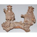 A Far Eastern hardwood carving, modelled as two figures upon a branch