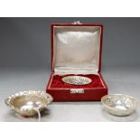 A cased pierced and embossed white metal bonbon dish, stamped Silver; together with a pair of