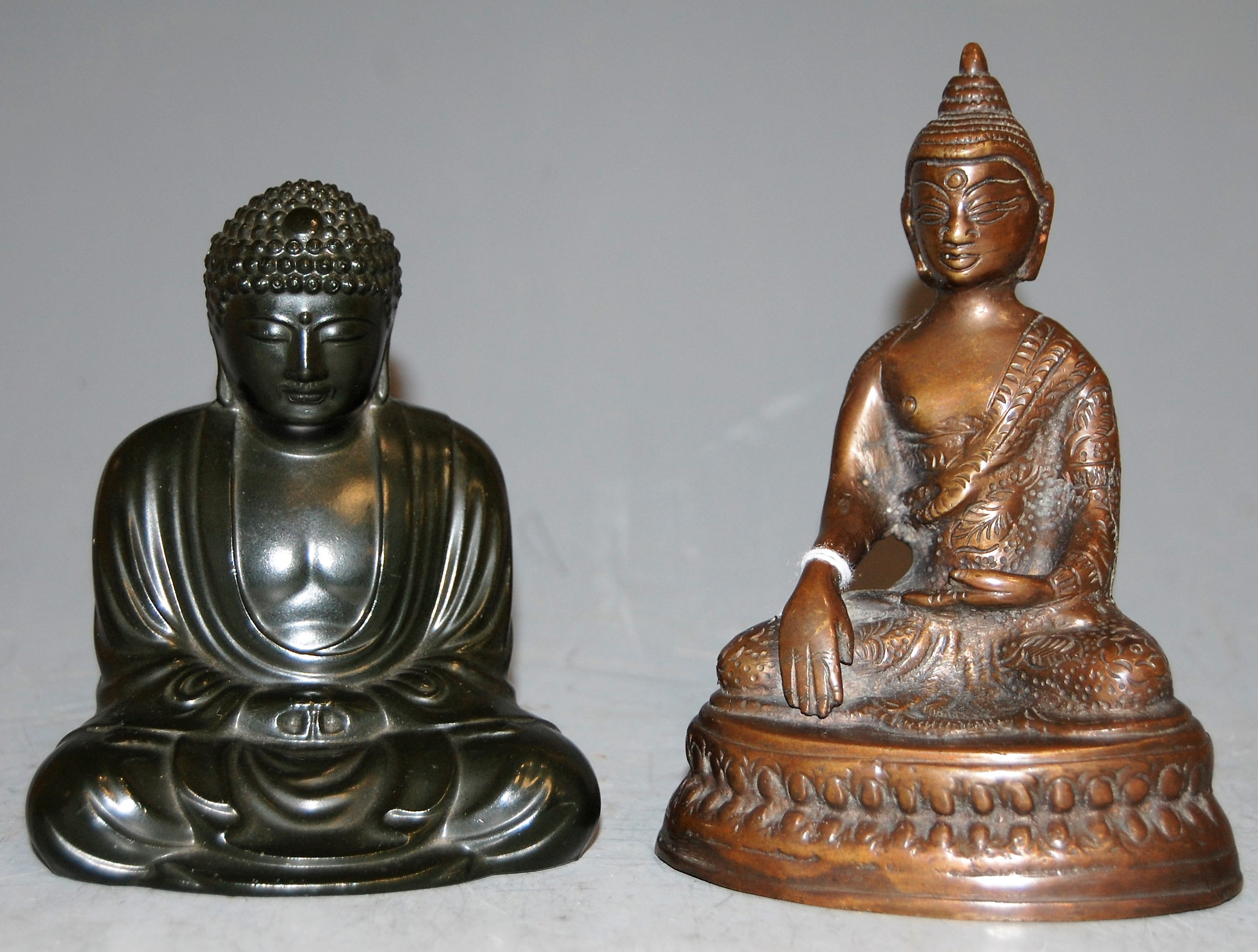 A Tibetan bronze Buddha in seated lotus pose, h.15cm; together with one other seated Buddha (2)