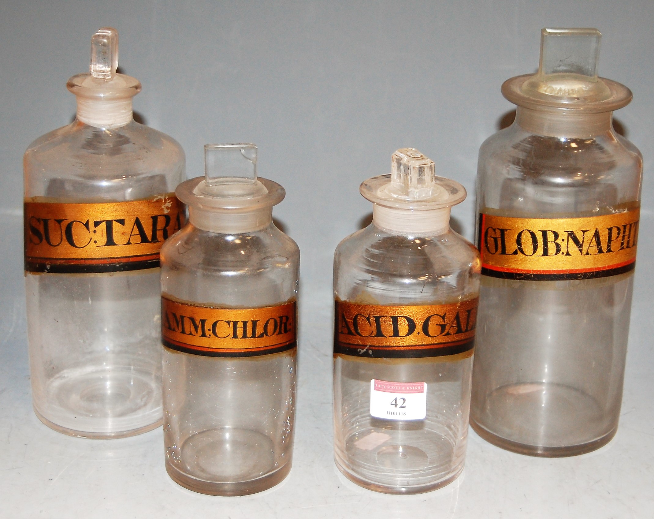 Four early 20th century apothecary jars and stoppers, each with annotation, largest h.25cm