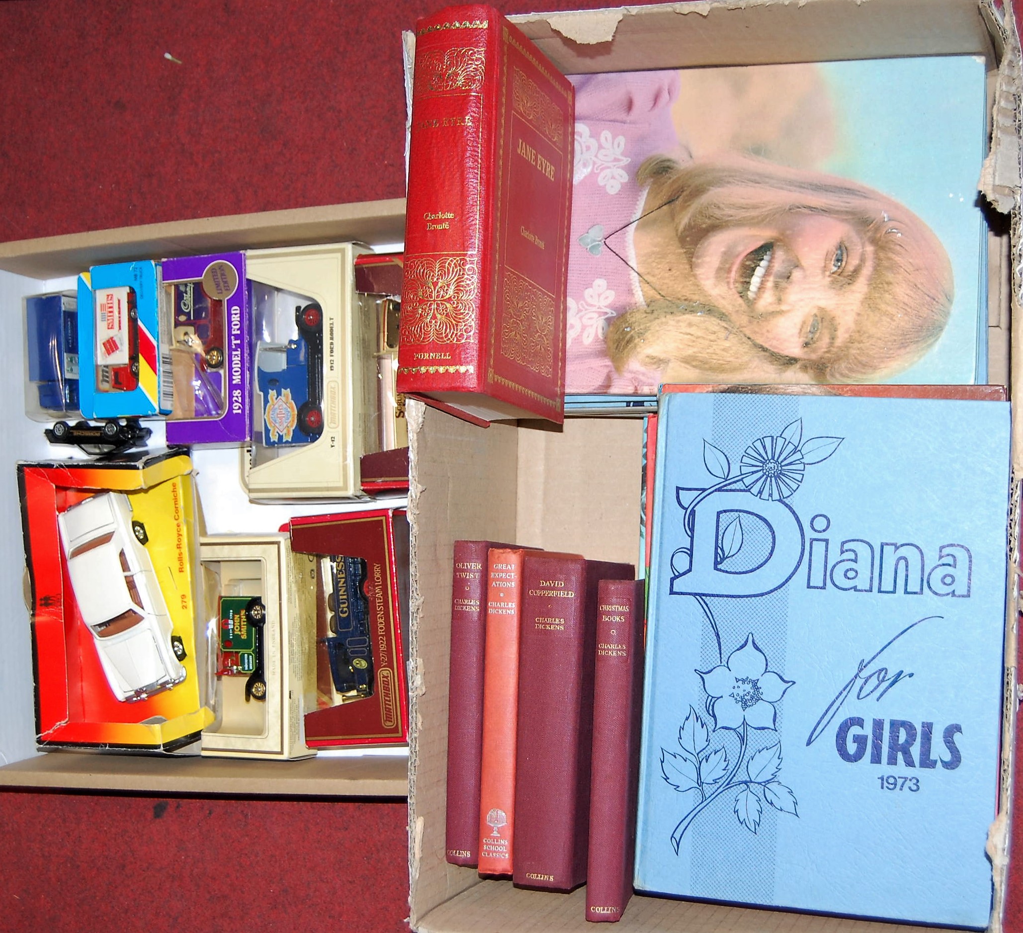A box of assorted books to include children's annuals together with boxed modern issue diecast toy