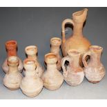 A terracotta ewer, height 28cm, together with two smaller examples, and various terracotta vases (