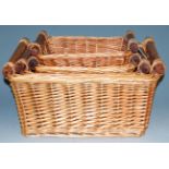 A graduated set of three wicker baskets, largest 38x47cm