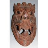 Two mid-20th century Nepalese wooden masks, the largest 37 x 19cm
