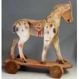 A mid-20th century childs' painted push-along horse, h.53cm