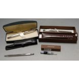 A Cross silver cased ball point pen boxed together with two other Cross silver ballpoint pens and