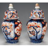 A pair of Japanese imari porcelain vases and covers, h.23cm