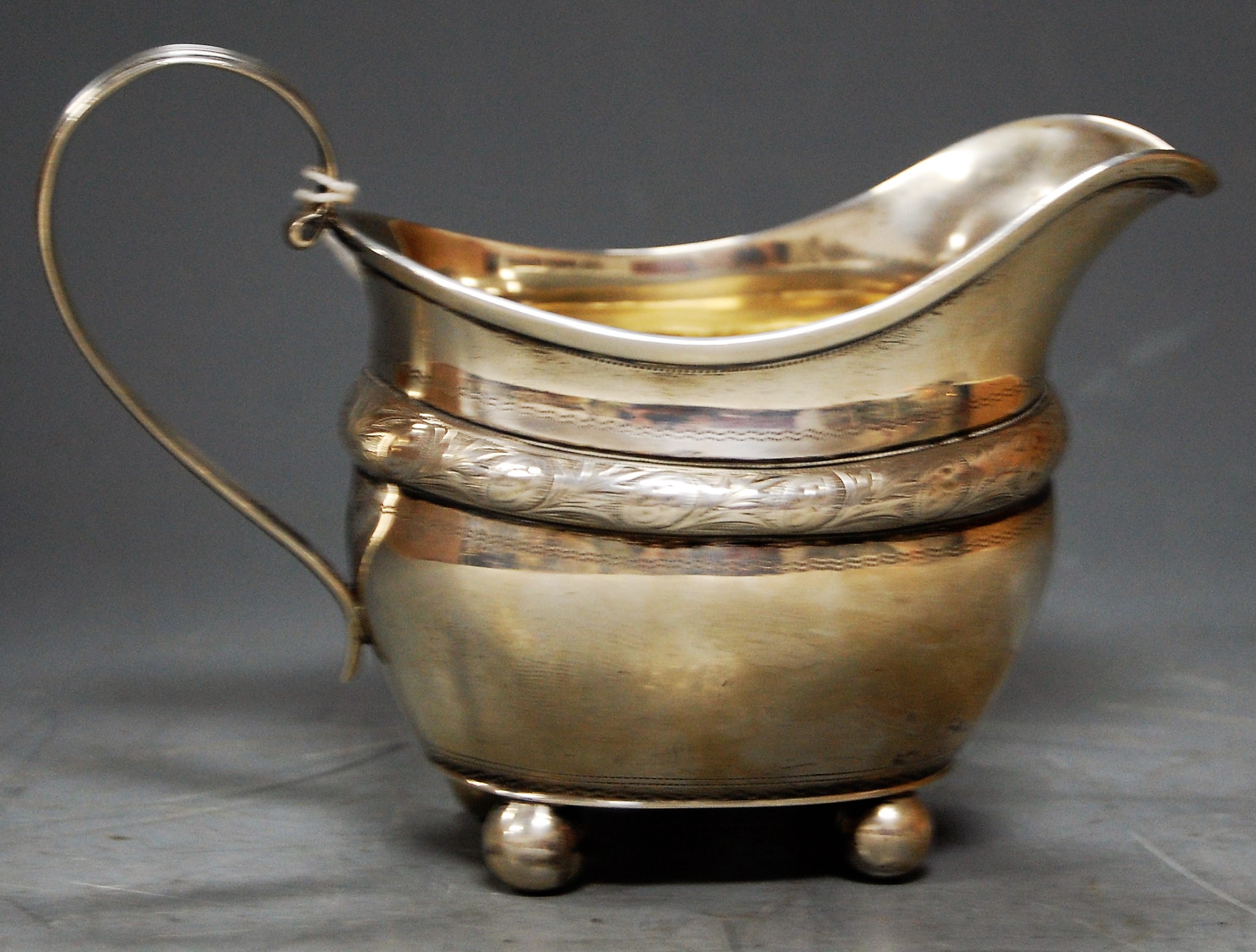 An Edwardian silver cream jug on ball feet, 5.5oz, London 1906, h.9.5cm