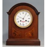An Edwardian mahogany cased mantel clock, having enamelled dial with Roman numerals and eight day