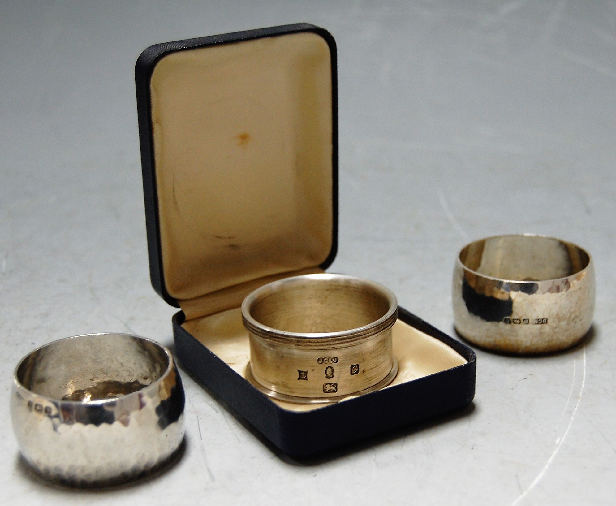 A 1978 British Engine Centenary silver napkin ring cased with booklet together with two other silver