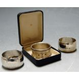 A 1978 British Engine Centenary silver napkin ring cased with booklet together with two other silver