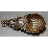 A cast silver caddy spoon the bowl in the form of a shell and the handle in the form of a lady and