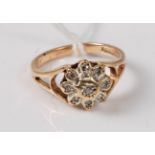 A 9ct gold diamond cluster ring, all illusion mounted with open tapered shoulders and plain band