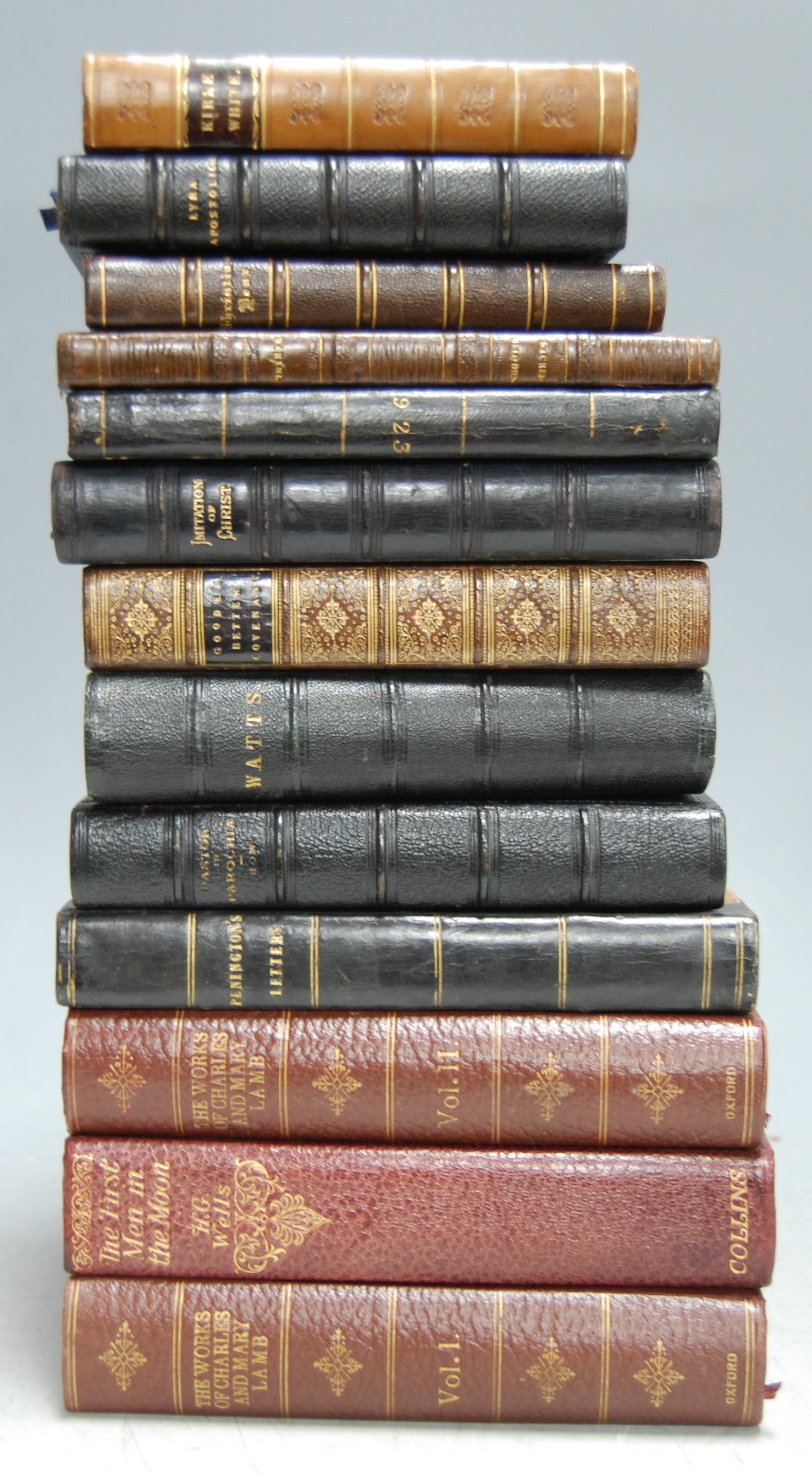 A small collection of leather bound volumes, to include The First Men in the Moon by H.G. Wells, the