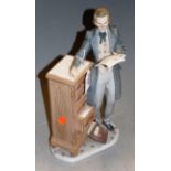 A Lladro porcelain figure of a scholar standing beside a five drawer chest, impressed number 5213