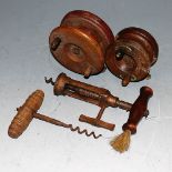 Two circa 1900 wooden fishing reels; together with two circa 1900 corkscrews (4)
