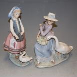A Lladro porcelain figure of a girl feeding a duck, h.26cm; together with one other of a seated girl