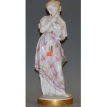 A circa 1900 Meissen Dresden porcelain figurine of a maiden cradling a dove, decorated in bright