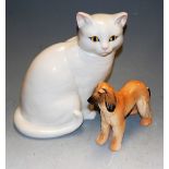 A Staffordshire white glazed ceramic model of a seated cat; four Bradford Exchange collectors