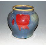 A Chinese glazed stoneware vase, of squat baluster form, underglaze decorated in shades of powder