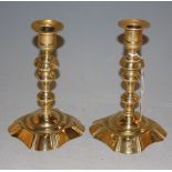 A pair of 18th century brass candlesticks with multiknopped stems, 18cm