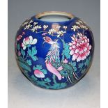 A Chinese stoneware ginger jar, enamel decorated with flowers and foliage on a blue ground (cover