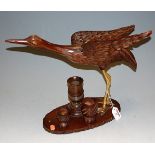 A carved softwood model of a crane on stand