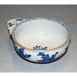 A Chinese blue and white 'bleeding' bowl, 18th century, the exterior painted with sprigs of flowers,