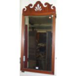 A contemporary mahogany rectangular bevelled wall mirror, having a fret carved top in the Georgian