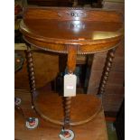 An early 20th century beaded oak demi-lune two-tier ledgeback barleytwist turned side table, w.61cm