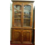 A mid Victorian mahogany round cornered bookcase cupboard, width 127cm