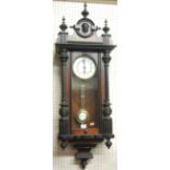 An early 20th century walnut and ebonised Vienna drop trunk wall clock