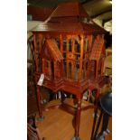 A contemporary Eastern stained teak and wire work bird cage on stand