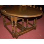 A contemporay moulded oak oval nest of nest of three occasional tables