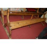 A late Victorian stained pine long church pew, length 283cm