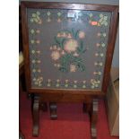 An oak framed fire screen, and one other, a tapestry topped stool, and one other, a glazed table top