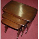 An Ercol dark elm nest of three occasional tables, the largest w.56.5cm