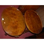 A pair of contemporary figured walnut oval tray-top occasional tables, on castors, w.67cm