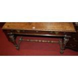 A Continental late 19th century carved walnut single drawer side table, raised on acanthus leaf