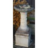 A reconstituted stone sundial raised on pedestal, height 102cm